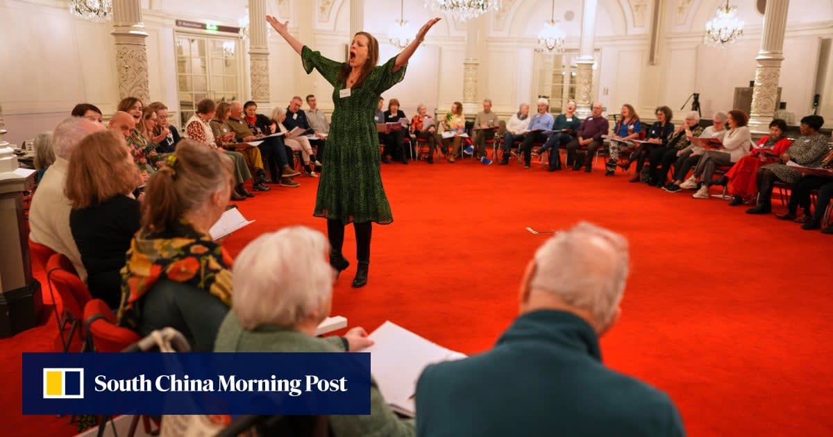 Seniors with dementia singing together in circle formation at ornate Amsterdam concert hall