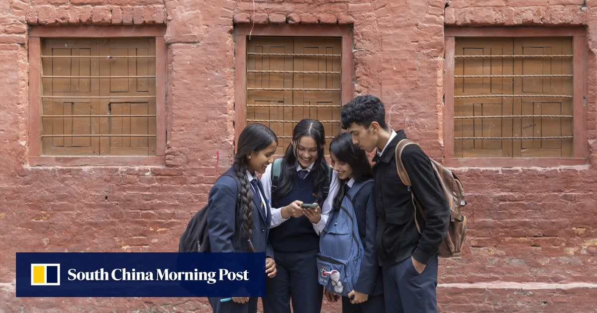 Nepalese students in school uniforms walking to class with backpacks and books