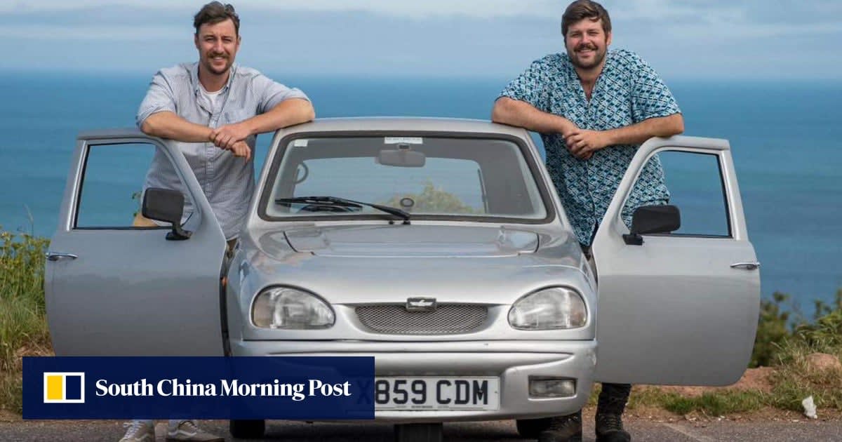 Silver three-wheeled Reliant Robin car with two men standing beside it in Africa