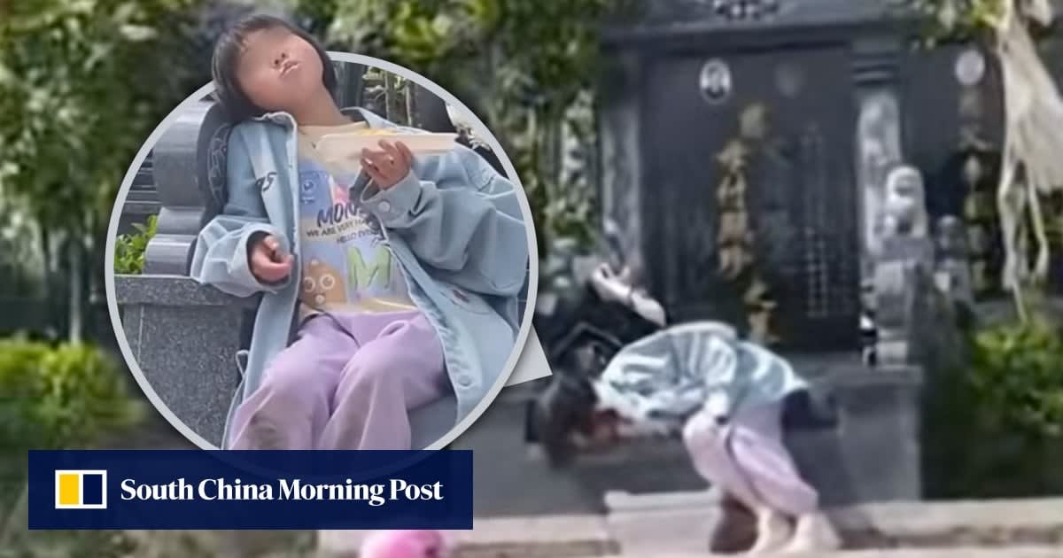 Young girl sitting peacefully at grandparents' tombs in Guizhou province, China, honoring their memory