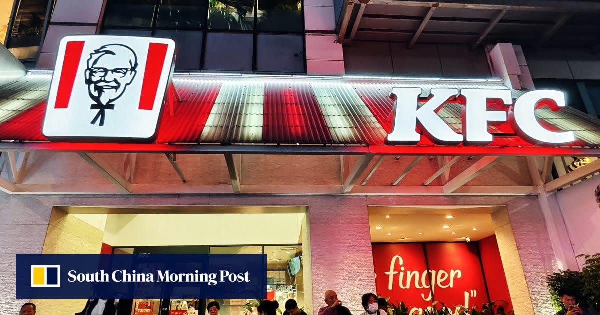 Electric vehicle charging at KFC drive-through restaurant with customer picking up food order