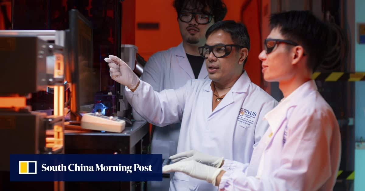 Scientist examining superconducting materials in advanced physics laboratory setting with research equipment