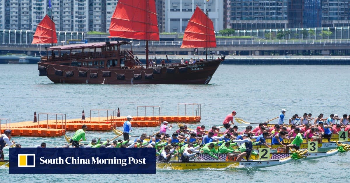 Colorful dragon boat racing teams paddle in sync across Hong Kong's Victoria Harbour waterfront