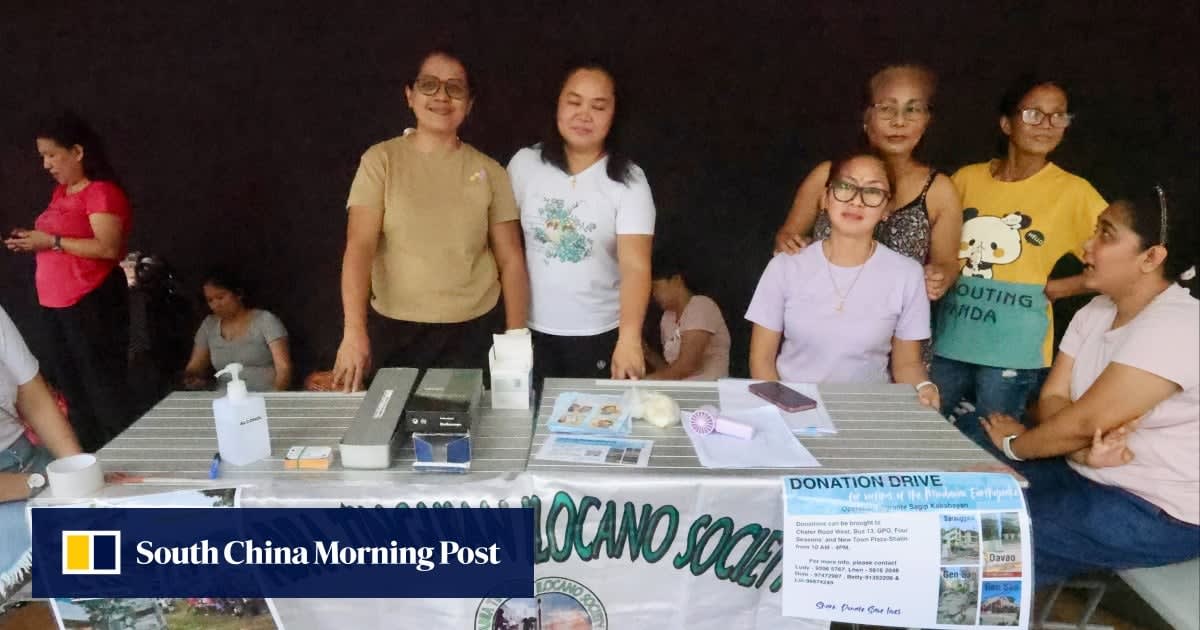 Filipino domestic workers collecting donations at outdoor station in Hong Kong for earthquake relief