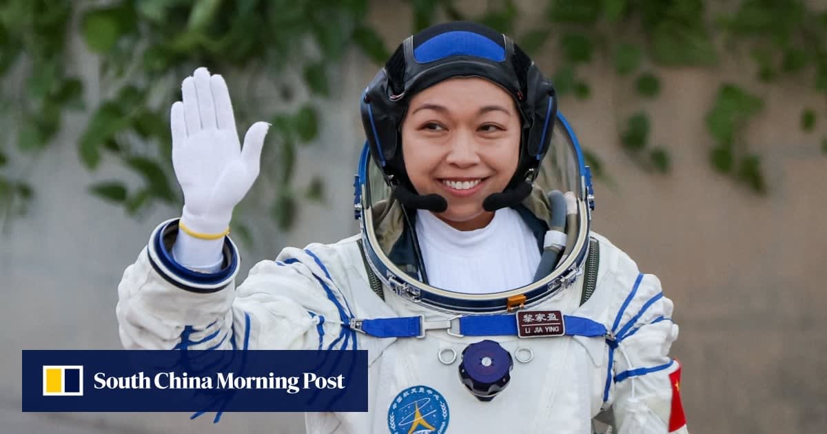 Astronaut in space suit waving from inside spacecraft during historic mission launch