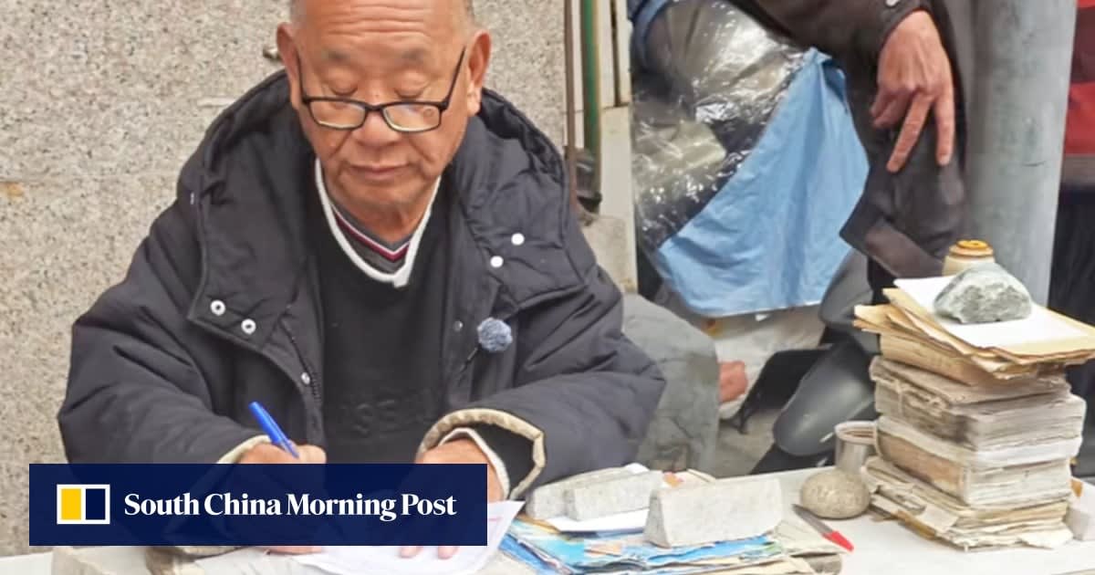 Elderly Chinese man Jiang Mingdian writing letter at desk with traditional pen and paper