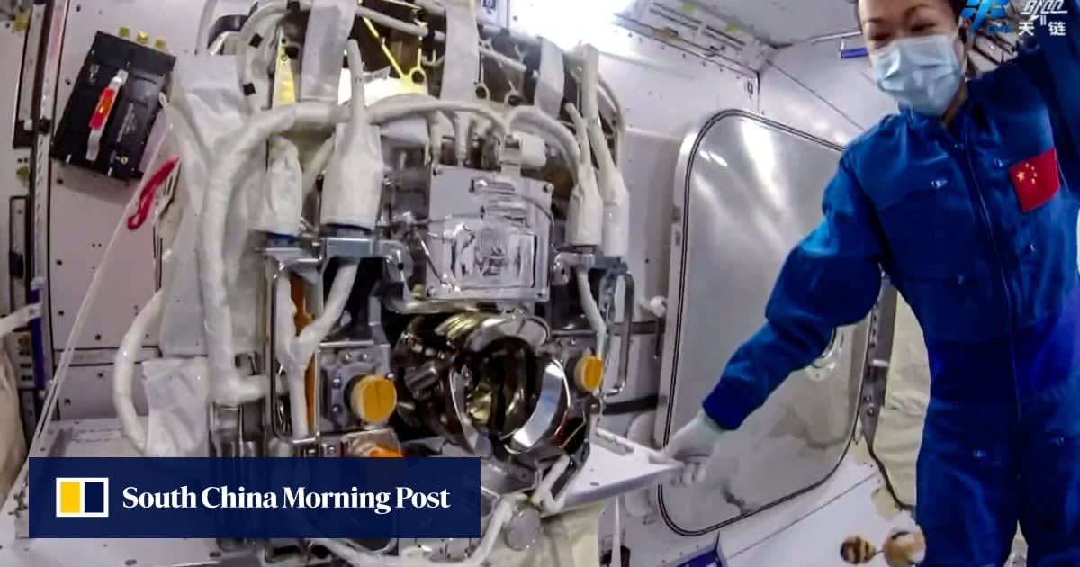 Astronaut installing scientific instrument on exterior of Tiangong space station in orbit above Earth