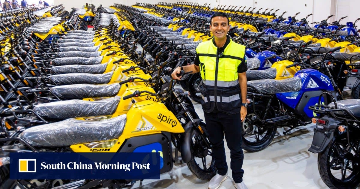 Electric motorcycle taxi parked at battery swapping station in African city