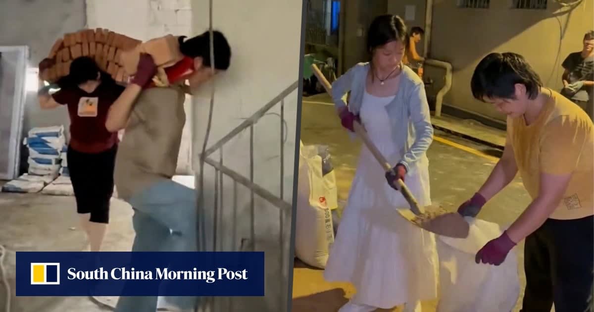 Mother and daughter carrying bricks on their backs at construction site in China