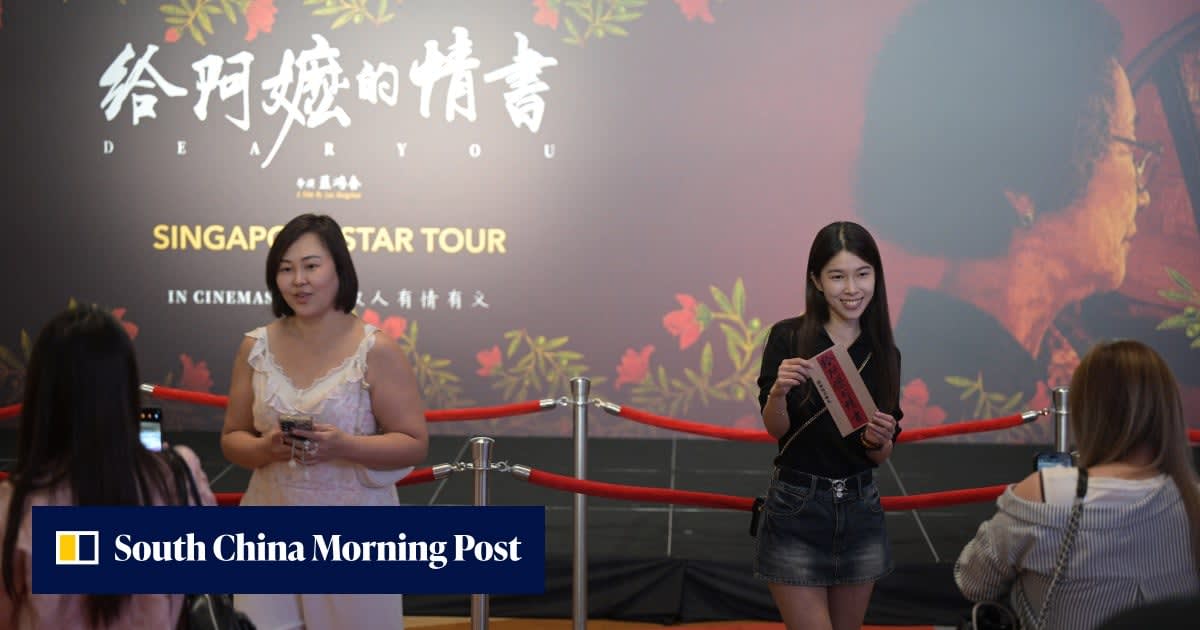 Singapore cinema marquee displaying Chinese dialect film titles alongside Mandarin versions