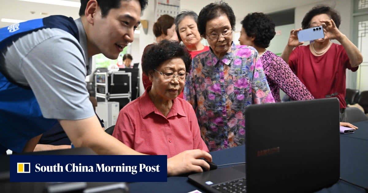 Elderly South Korean woman smiling while learning smartphone skills at community training center