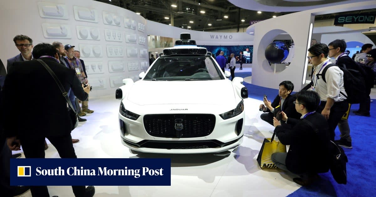 White Waymo autonomous electric vehicle driving on modern Singapore city street with greenery