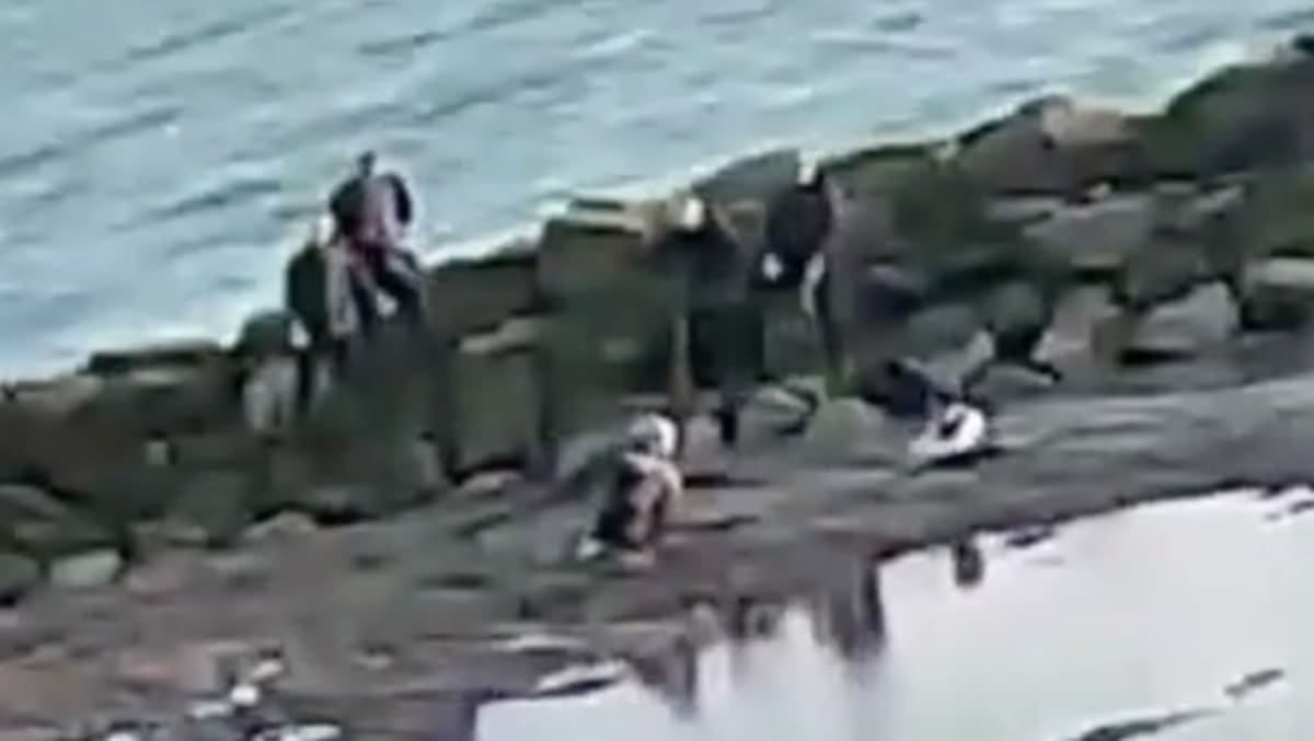 ** Theme park staff members working together to rescue people from beach sand