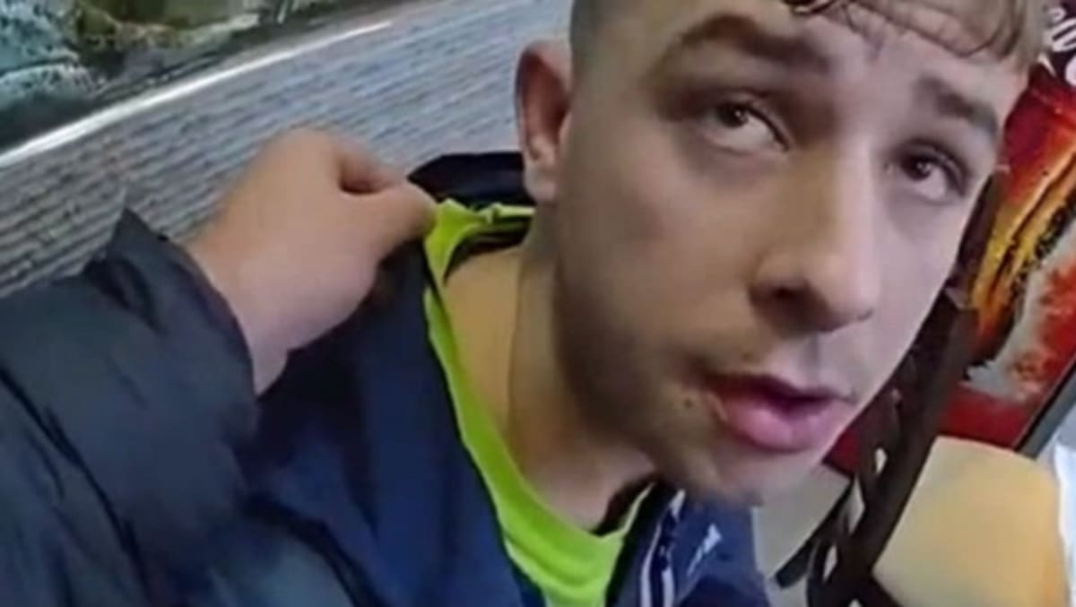 Police officer stands outside traditional British fish and chip shop in Kent, England