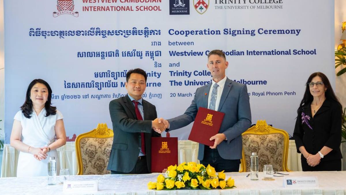 Cambodian and Australian educators shake hands at formal partnership signing ceremony in Phnom Penh
