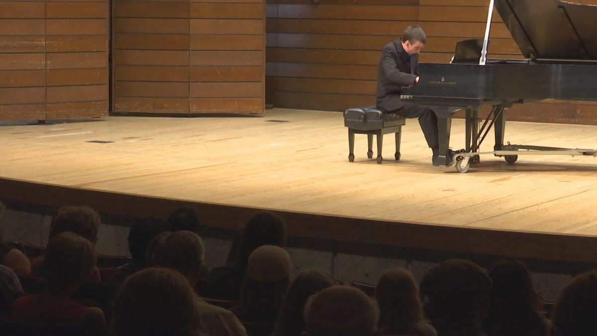 Young man performing at piano during charity concert for Make-A-Wish Foundation in Ashland Oregon