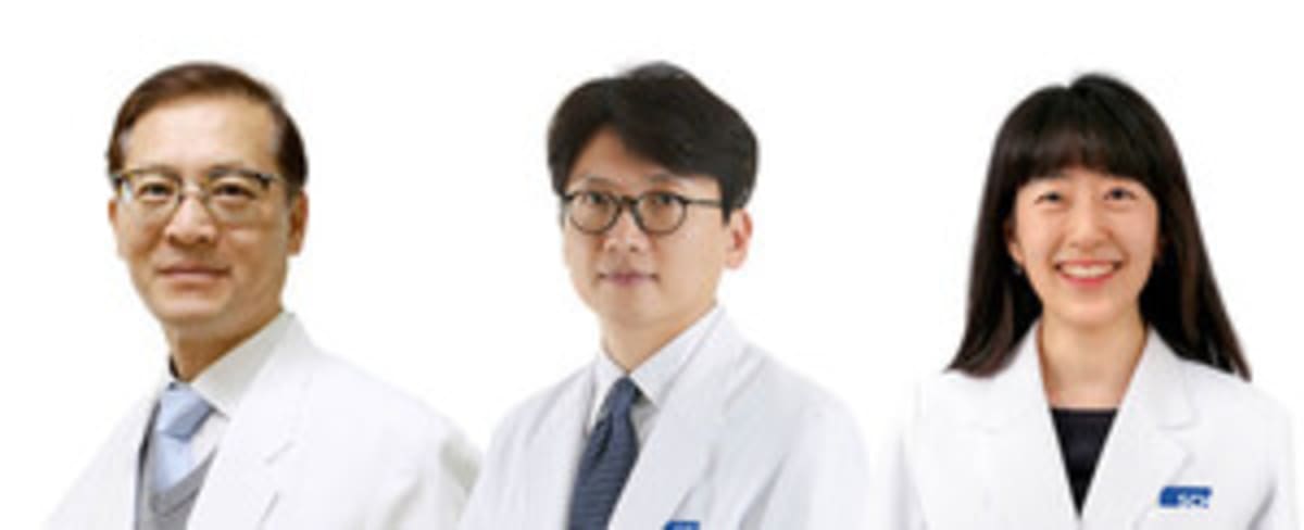 ** Three Korean professors in white medical coats standing together at hospital research facility