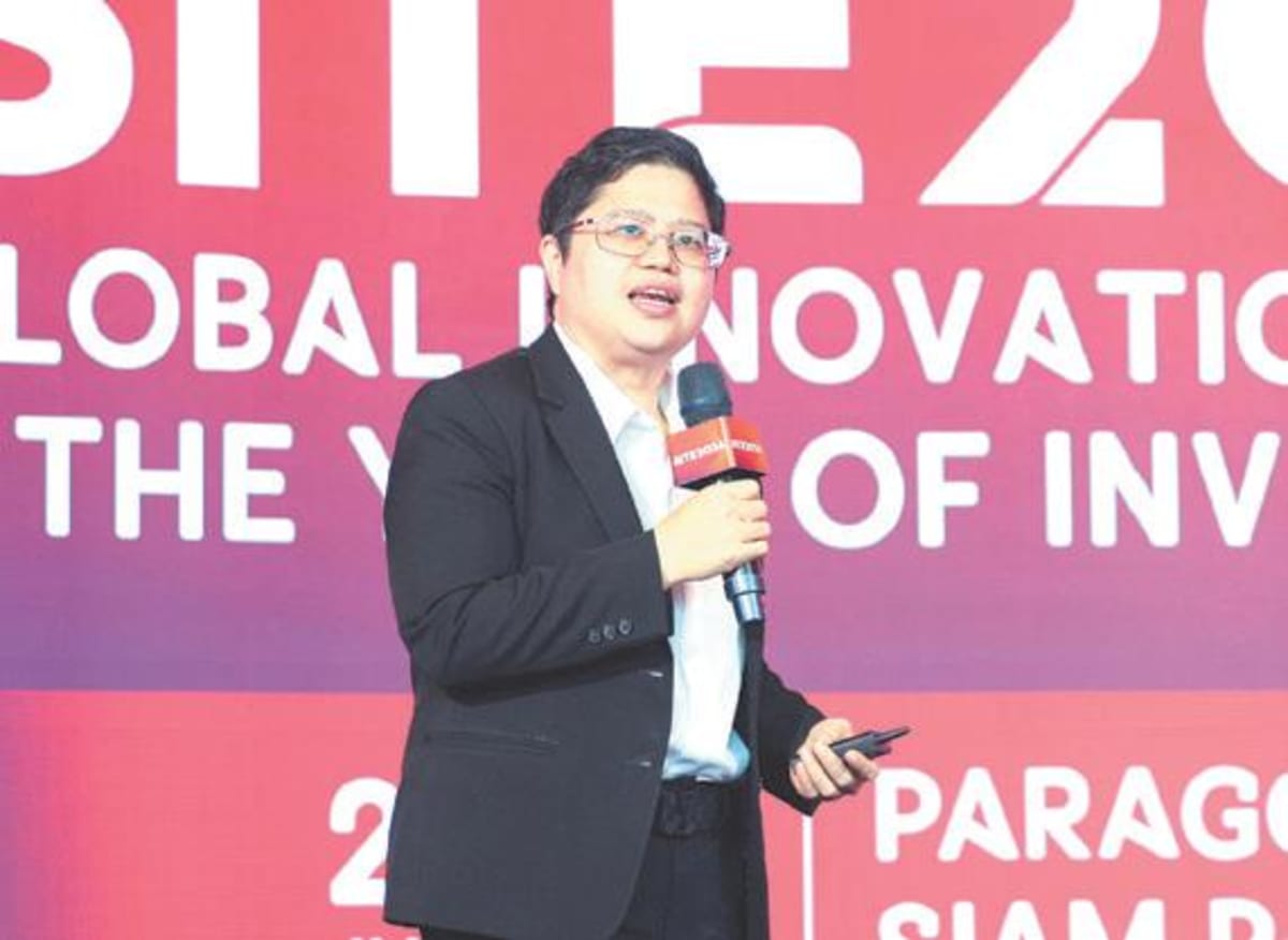 Innovators and investors networking at a modern technology expo in Bangkok, Thailand