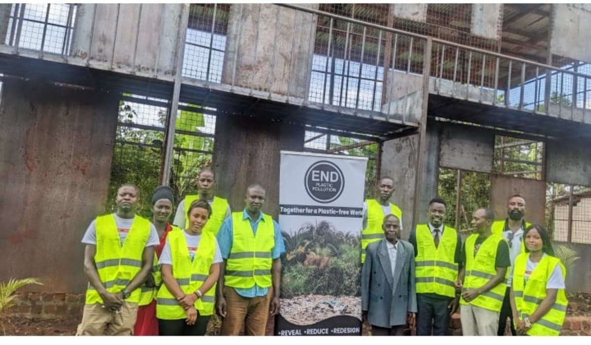 African community members sorting recyclable waste and organic materials for composting program