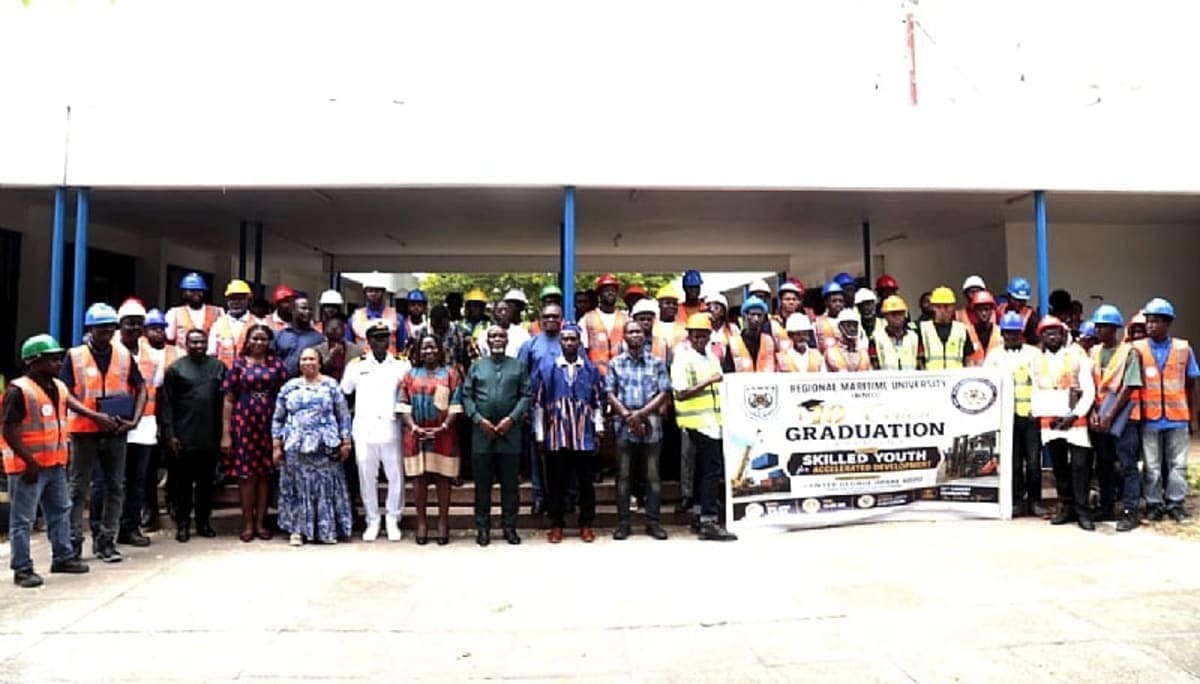 Young Ghanaian graduates in safety gear celebrating completion of heavy equipment operator training program