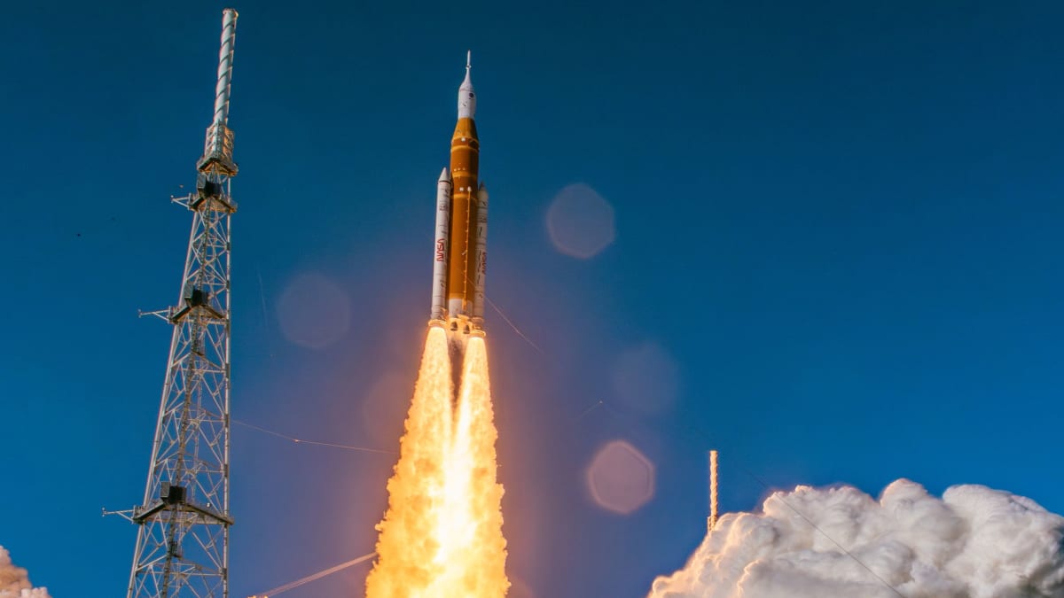 Artemis 2 rocket launching from Kennedy Space Center with crowds watching from Florida's Space Coast