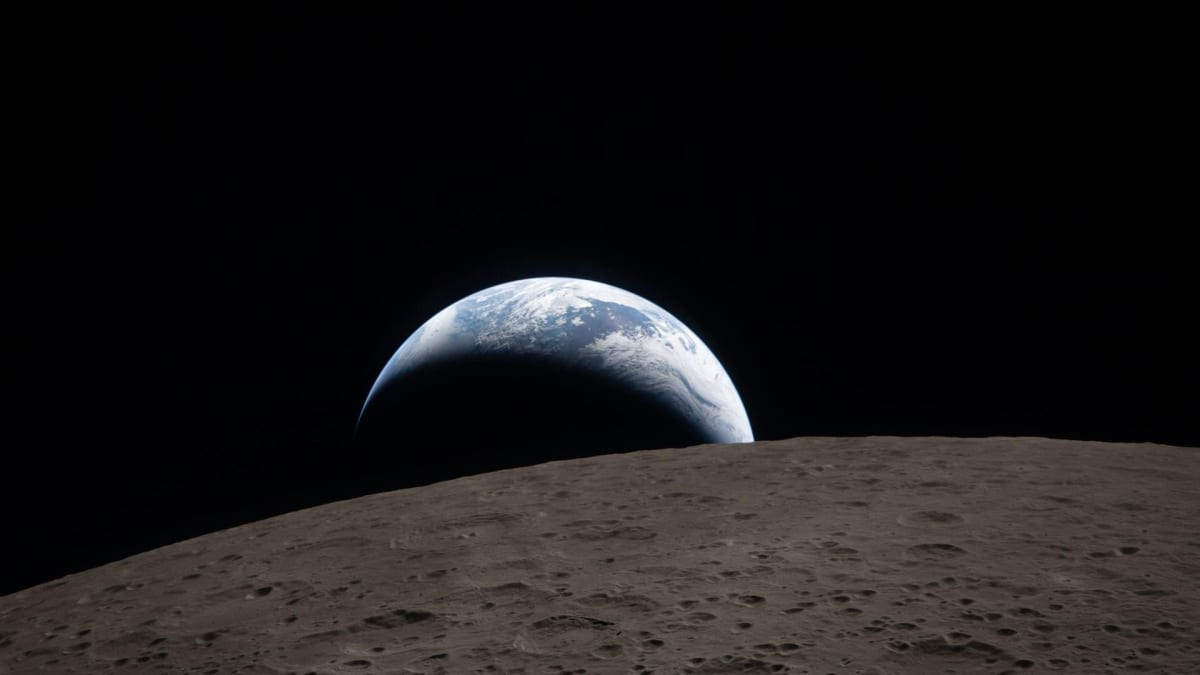 Crescent Earth setting behind the moon's curved horizon as seen from Artemis 2 spacecraft