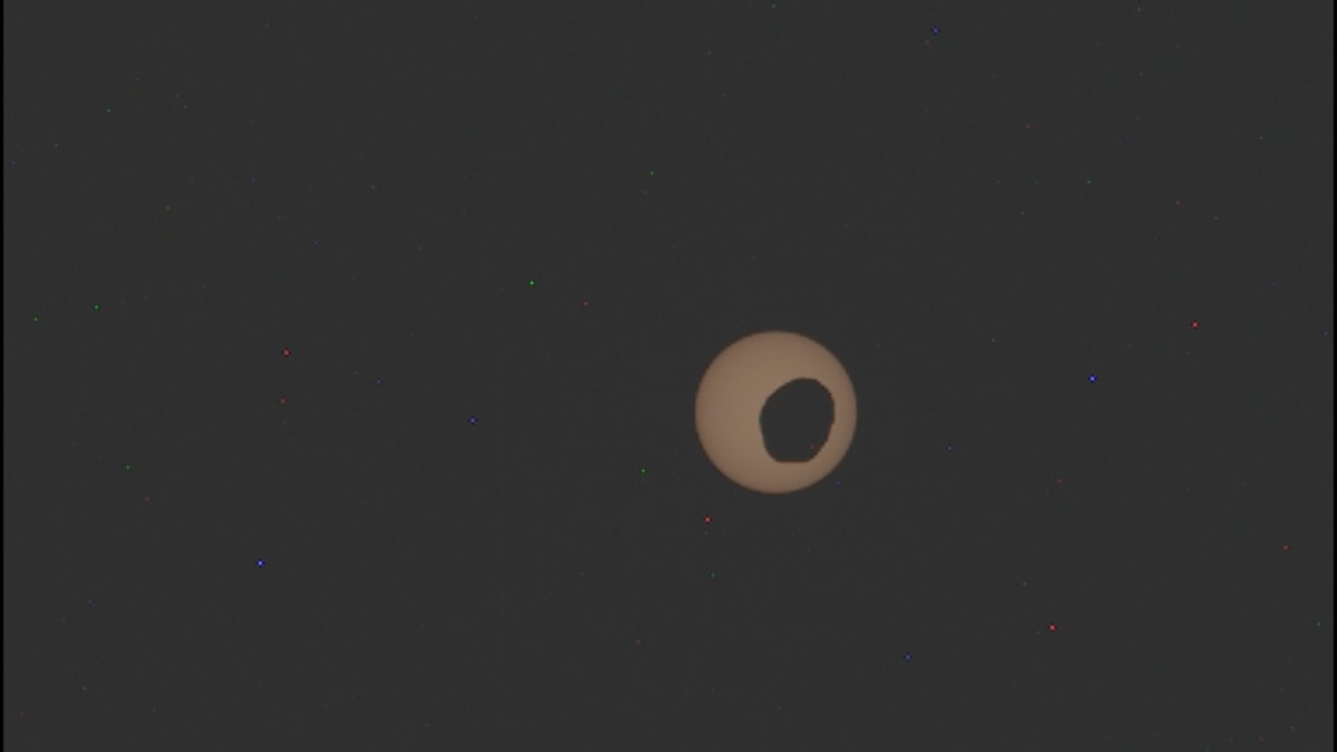 Mars' moon Phobos partially blocking the sun as seen from Perseverance rover on Martian surface