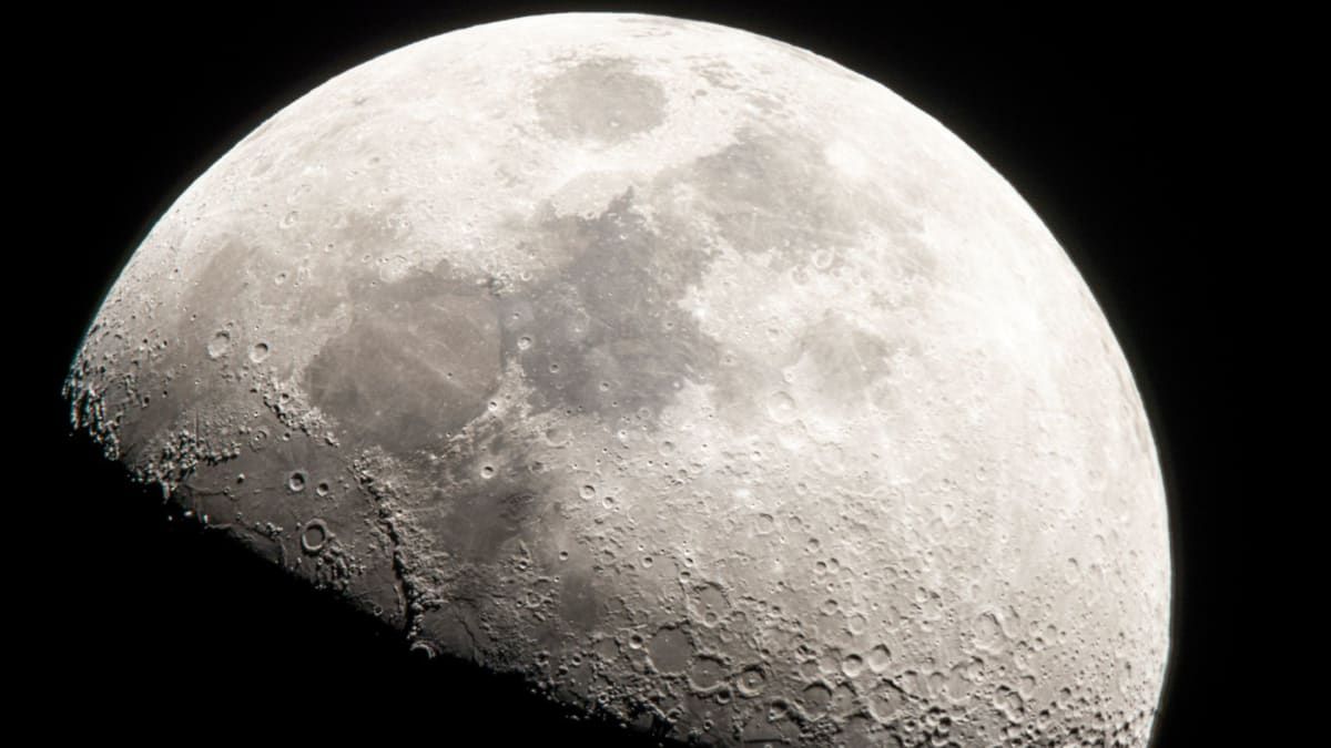 Detailed view of moon's northern hemisphere showing craters and surface features against black space