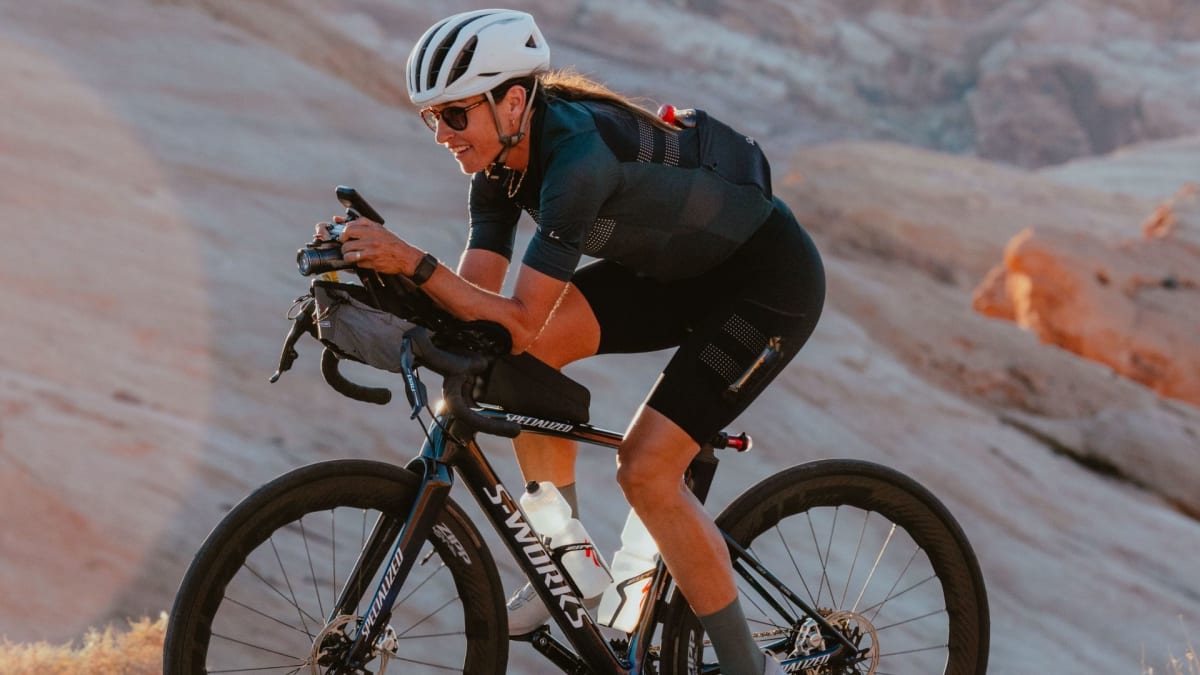 Cyclist Lael Wilcox training on road bike in aerodynamic position for world record attempt