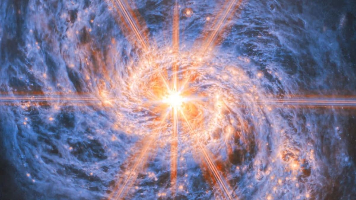 Galaxy M77 glowing brilliantly with radiating beams of light from its center captured by Webb Telescope