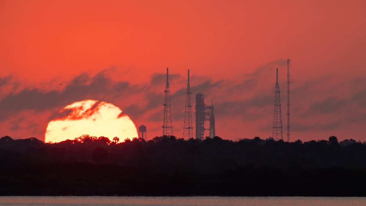 NASA's Space Launch System rocket silhouetted against sunrise at Kennedy Space Center launch pad