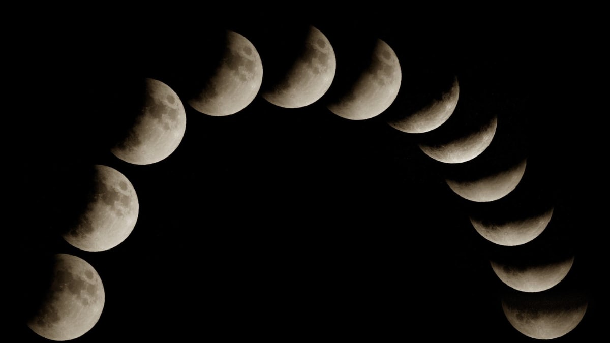 ** Deep partial lunar eclipse showing moon with thin bright crescent and large dark shadow