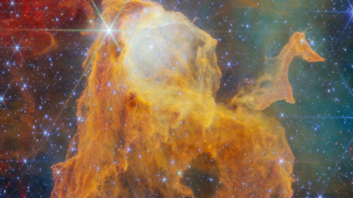 Colorful nebula cloud resembling open treasure chest with glowing stars inside captured by Webb telescope