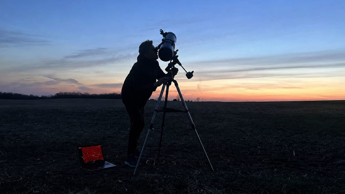 Celestron AstroMaster telescope set up in countryside under night sky for stargazing