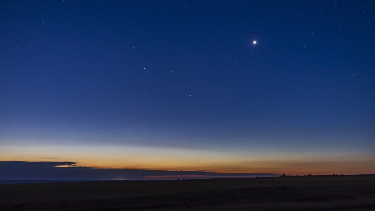 Brilliant Venus shining as bright evening star in twilight sky above horizon