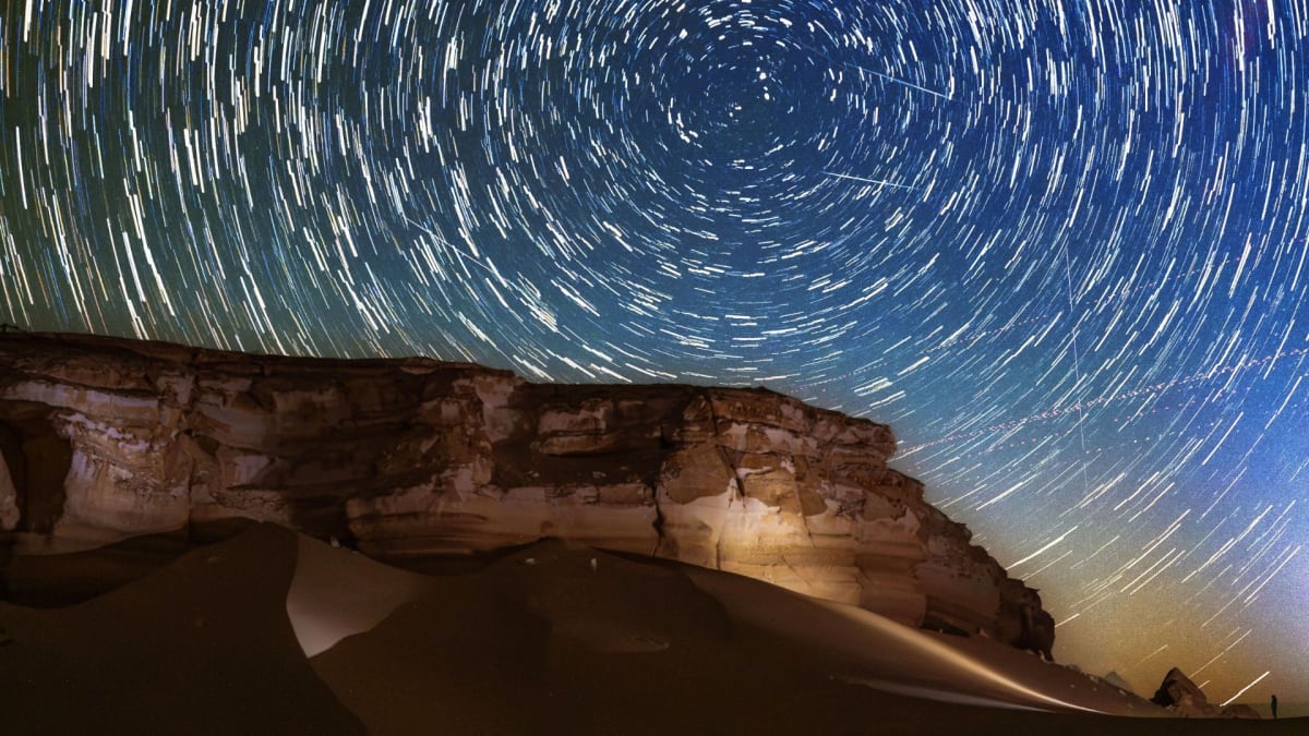 Circular star trails and bright meteor streaks over Egypt's Western Desert at night