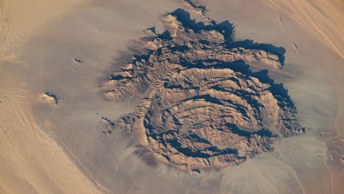 Aerial view of Mount Arkanu's circular stone rings with hat-shaped formation in Sahara Desert