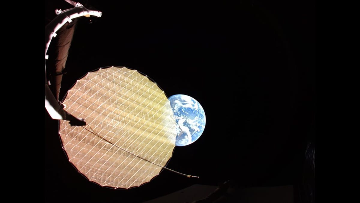 ViaSat-3 F2 satellite with fully deployed reflector disk against backdrop of blue Earth from space