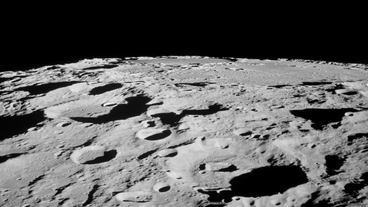 Permanently shadowed crater near the moon's south pole in deep darkness