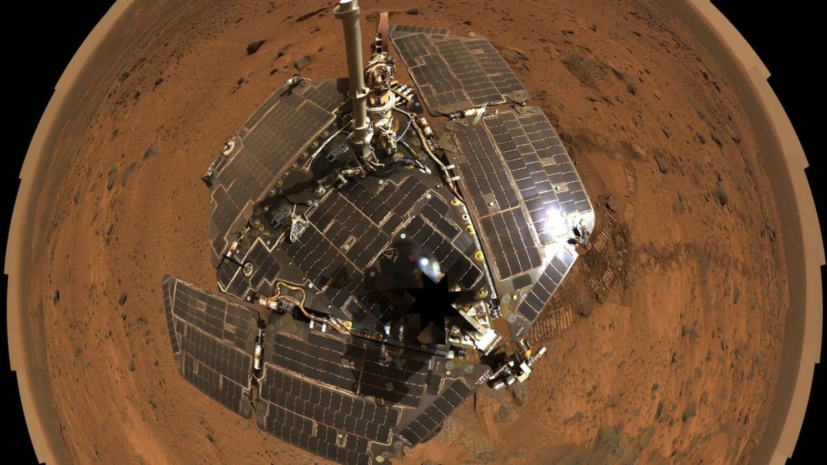 NASA Spirit rover on Mars surface with rocky red terrain and dust