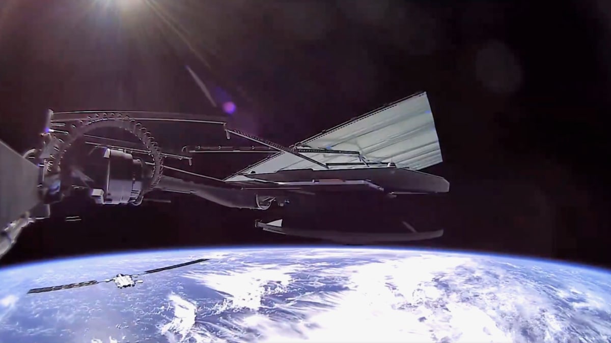 View from SpaceX Starlink satellite showing Earth's blue surface and neighboring satellites in orbit