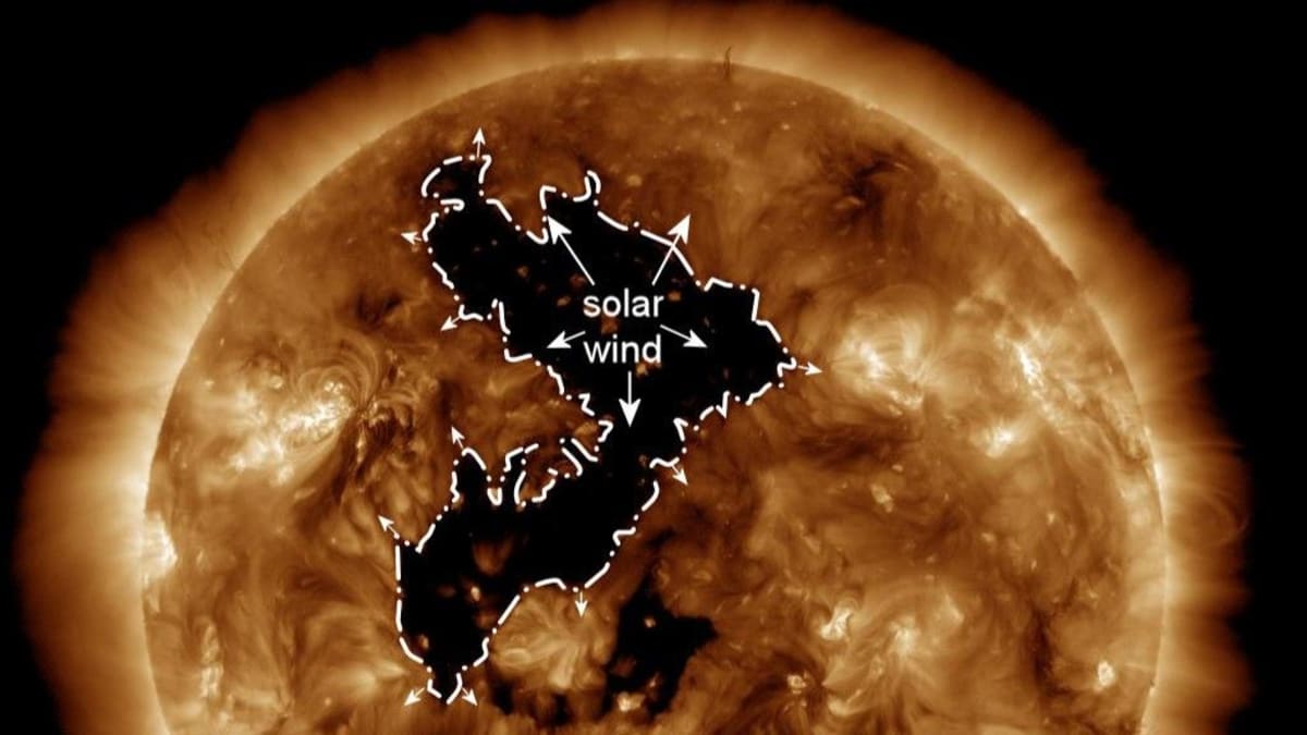 NASA satellite image showing large dark coronal hole in the sun's bright atmosphere