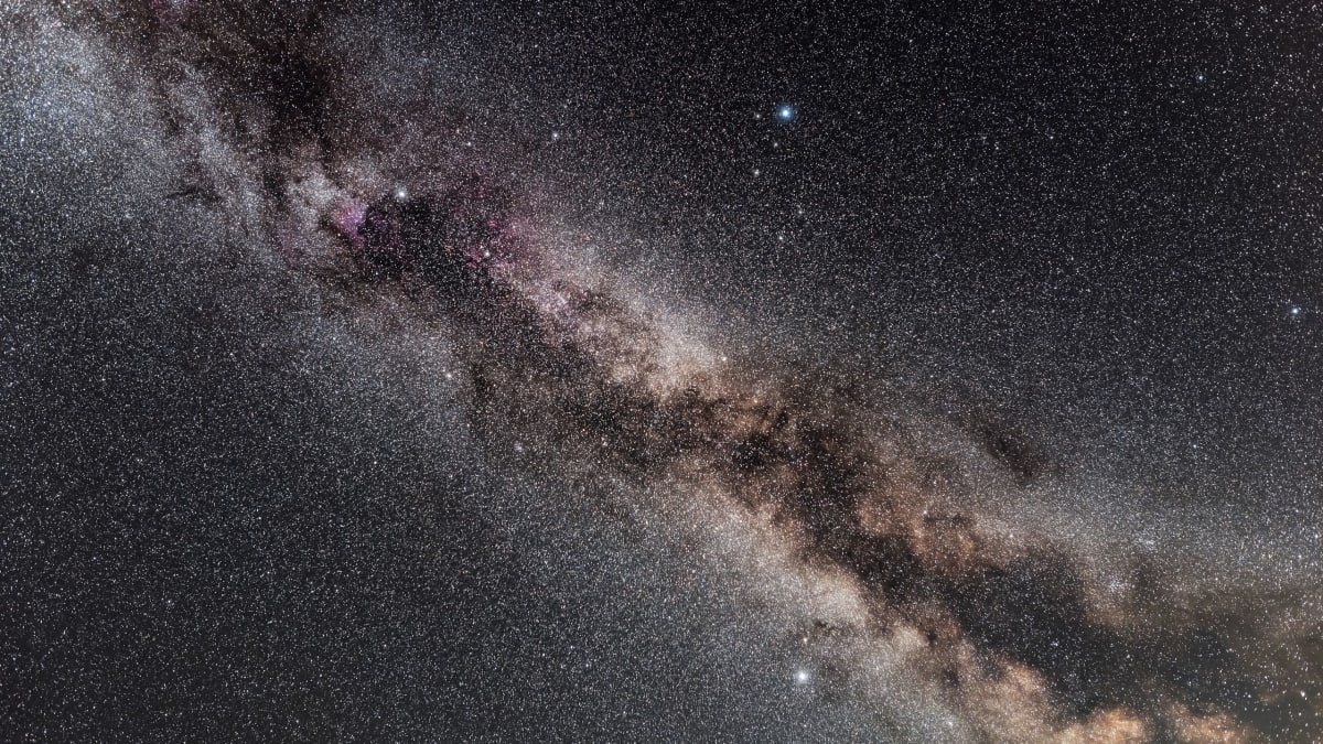 Three bright stars forming the Summer Triangle pattern against the glowing Milky Way galaxy