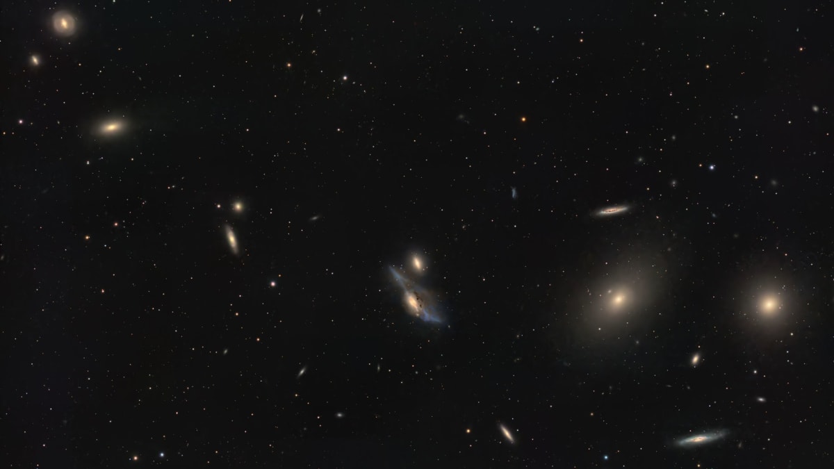 Two colliding spiral galaxies nicknamed The Eyes with streams of cosmic dust between them