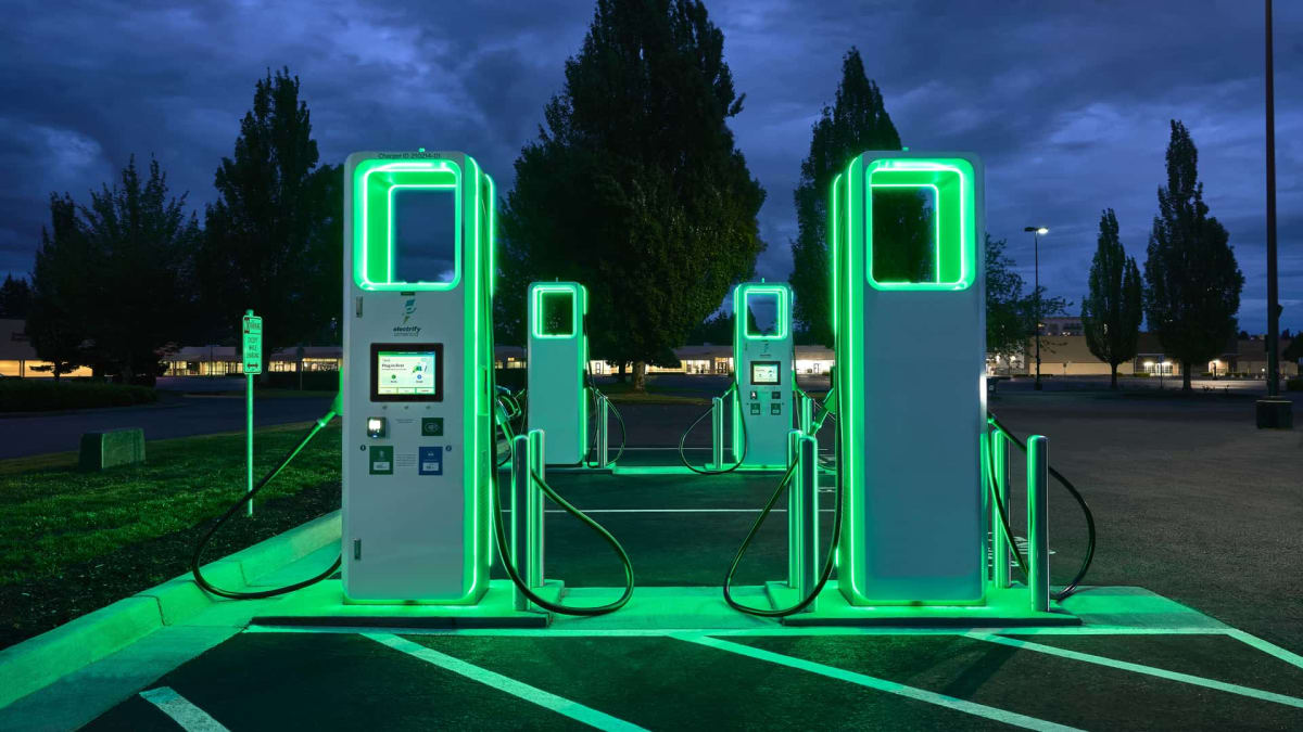 Electrify America charging station with modern EV plugged in for fast charging session