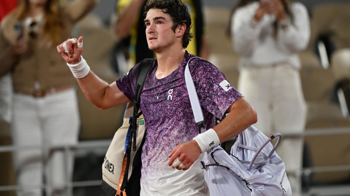 Young Brazilian tennis player João Fonseca celebrating on clay court at French Open