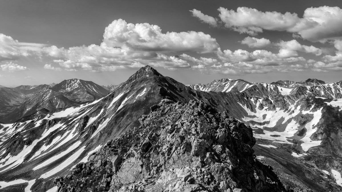 Rescue helicopter hovering over rugged Colorado mountain peak in Sawatch Range near Aspen