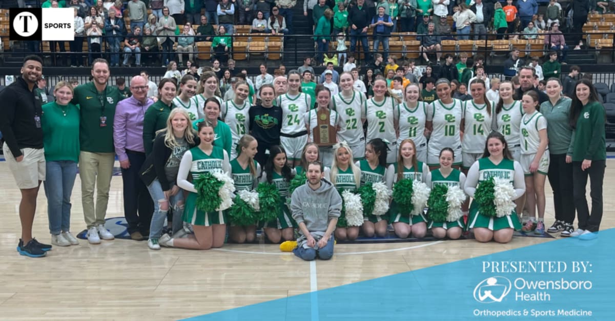 Owensboro Catholic Lady Aces basketball team celebrating their regional championship victory together