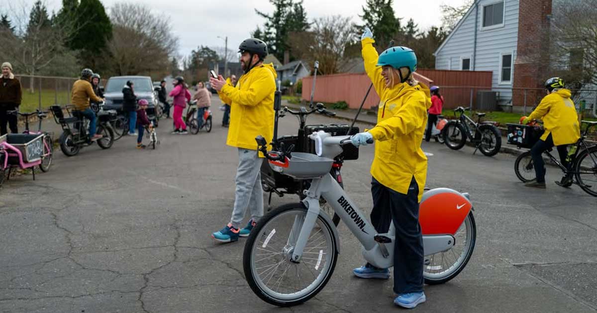 Zara Larsson and Coach Balto riding bikes leading hundreds of Portland students