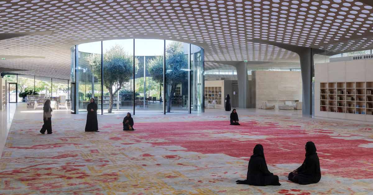 Bright modern mosque interior with perforated roof allowing natural light to illuminate open prayer space